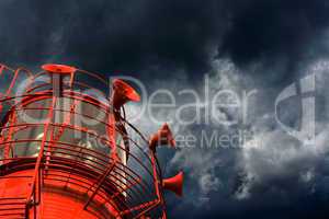 Red lightship with fog horns against storm clouds