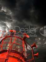 Red lightship with fog horns against storm clouds