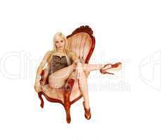 Girl sitting in armchair.