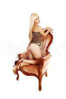 Girl kneeling in armchair.