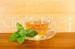 Herbal tea with mint on a wooden board