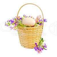 Eggs with flowers in a wicker basket