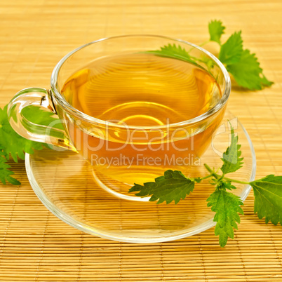Herbal tea with nettles on a bamboo mat