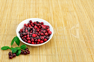 Lingonberry in a white cup on a bamboo mat