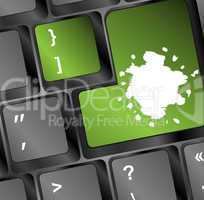 Computer keyboard with green colored enter key and blots