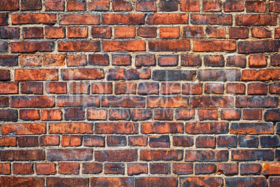 Old weathered red brick wall as background