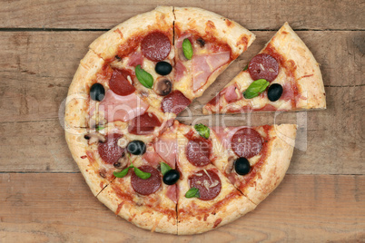 Geschnittene Pizza Speciale auf Holztisch