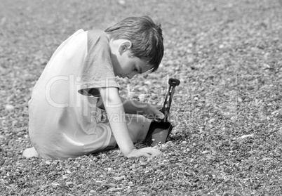 Boy playing in pebble