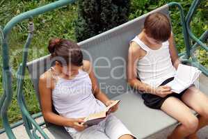 Teen girl and boy reading