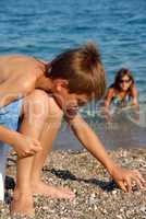 Boy playing in pebble