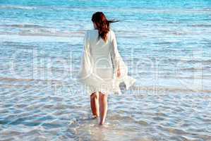 Woman in white dress at seaside