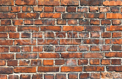 Old weathered red brick wall as background