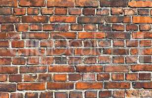 Old weathered red brick wall as background