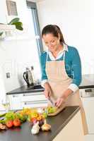 Woman cutting vegetables kitchen standing happy