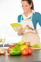 Happy woman preparing recipe vegetables cooking kitchen