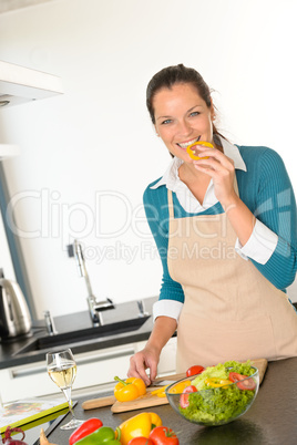 Young woman tasting preparing kitchen vegetables dinner