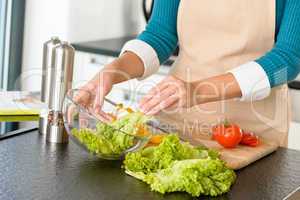 Woman preparing salad vegetables kitchen cooking food