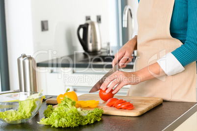 Cook woman cutting tomato salad knife kitchen