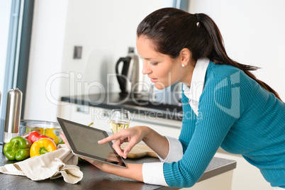 Young woman reading recipe tablet kitchen searching