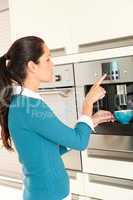 Young woman setting coffee maker machine kitchen