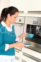 Cheerful woman making coffee machine kitchen cup