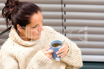 Woman drinking cup tea knitted sweater relaxing
