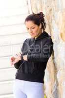 Young woman checking after exercising sport sweatsuit