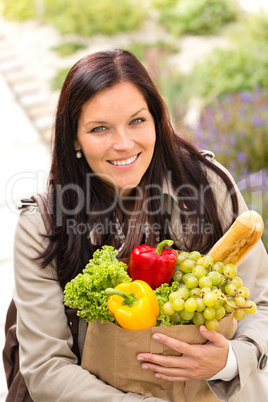 Smiling woman shopping vegetables groceries paper bag