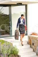 Young businesswoman rushing luggage going busy traveling