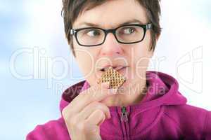 Woman eating cookie