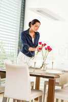 Woman decorating red roses dining room wife