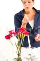 Woman setting table romantic dinner roses Valentine's