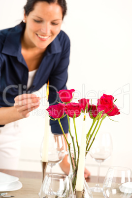 Happy woman lighting candle lunch guests dining