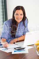 Happy businesswoman working office writing calculating finance