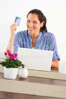 Smiling woman shopping online home credit card