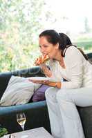 Woman eating sandwich lunch breakfast home sofa