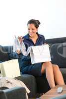 Cheerful woman looking clothes gift present home