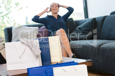 Cheerful woman talking phone shopping bags shopaholic