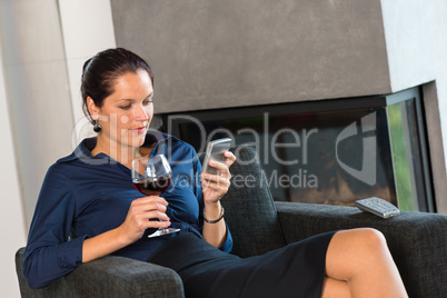 Woman businesswoman texting mobile phone living room