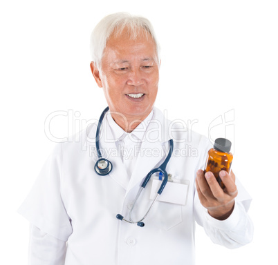 Asian senior doctor holding a bottle of pills