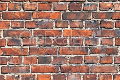 Old weathered red brick wall as background