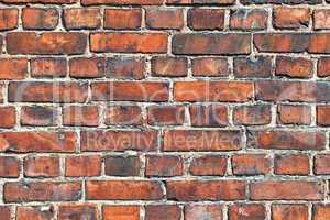 Old weathered red brick wall as background