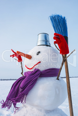 Lonely snowman at a snowy field