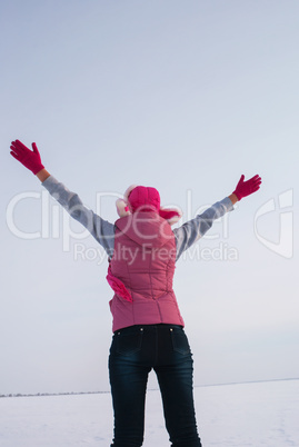 Teen girl staying with raised hands