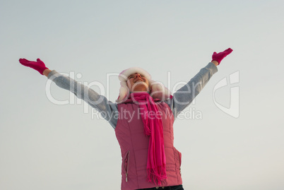 Teen girl staying with raised hands