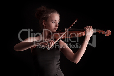 Young woman playing violin on black background