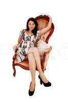 Woman sitting on armchair.