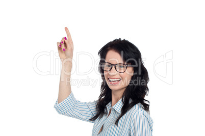 Happy brunette in eyeglasses gesturing upwards