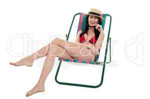 Seductive bikini woman relaxing on a deckchair