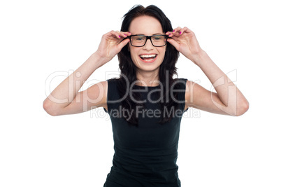 Charming lady adjusting her eyeglasses Charming lady adjusting her eyeglasses